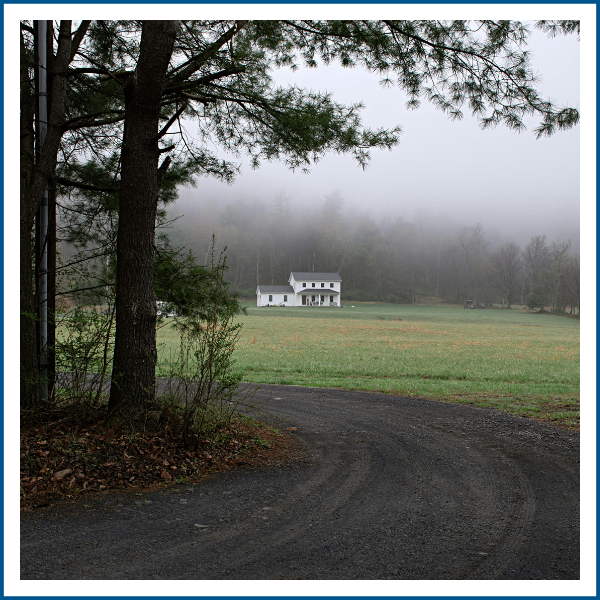 A rural home on a dirt road.